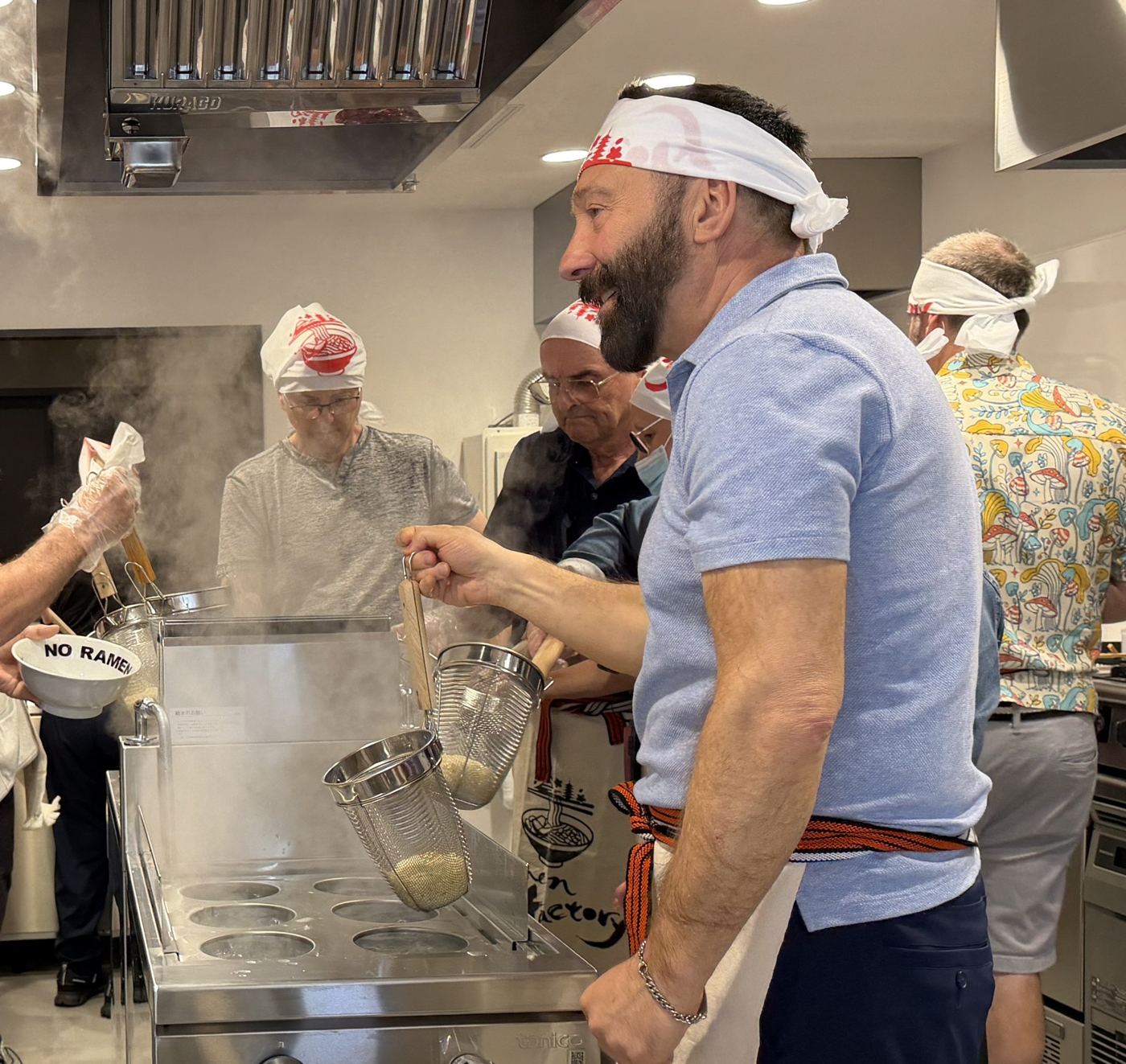 Team members working in the ramen kitchen